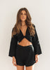 Hannah wearing the Avalon Tie-Up as a wrap top and Avalon Short in Black 100% LINEN.