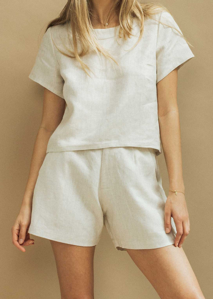 Close up of our Augusta Set in Sand Linen. A slightly cropped t-shirt style shirt paired with high waisted trouser shorts.