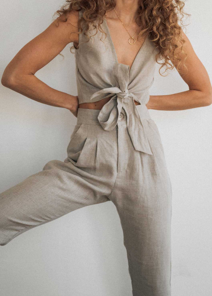 Close up of our Ballina Set in Oat. The Ballina Tie-Up is tied at the front and paired with our high waisted Ballina Trouser.