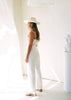 The backside of our Marlo Jumpsuit in Coconut, which is an off-white linen. Shot in Studio.