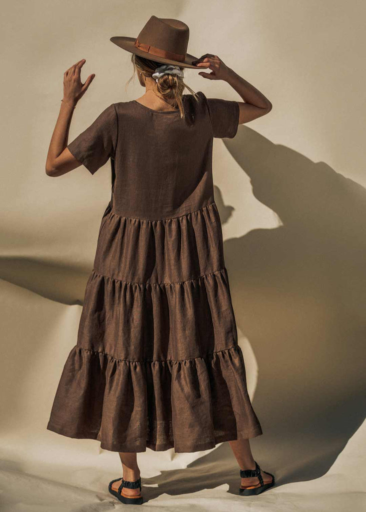 The Elwood Maxi dress in mocha. Showing off the backside and the beautiful tiers of the timeless design.