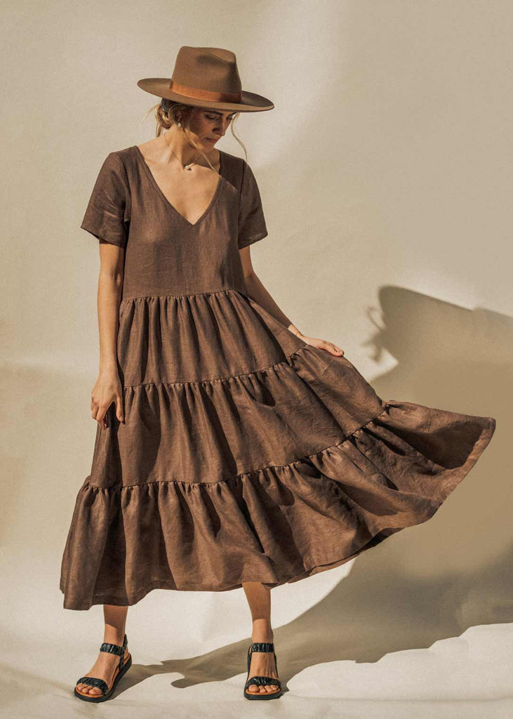 The Elwood Maxi dress in Mocha brown. The model shows the beautiful layers and tiers of the dress.